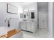 Bright bathroom featuring a soaking tub and a modern vanity with double sinks and a stylish mirror at 4064 Sunny Day Way, Kissimmee, FL 34744