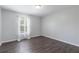 Bedroom featuring vinyl floors, light walls, a window with curtains and a modern ceiling light at 4064 Sunny Day Way, Kissimmee, FL 34744