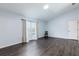 Bright bedroom with hardwood floors, neutral walls, and a large window at 4064 Sunny Day Way, Kissimmee, FL 34744