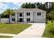 Charming two-story home with a palm tree, long driveway, and well manicured landscaping at 4064 Sunny Day Way, Kissimmee, FL 34744