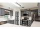 Updated kitchen with stainless steel appliances, white countertops, gray cabinets and white subway tile backsplash at 4064 Sunny Day Way, Kissimmee, FL 34744