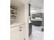Stylish kitchen area with white and gray cabinets and stainless steel appliances at 4064 Sunny Day Way, Kissimmee, FL 34744