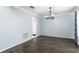 Bright living room with wood flooring, crown molding, and a modern chandelier at 4064 Sunny Day Way, Kissimmee, FL 34744