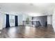 Open living space with hardwood flooring and a large window at 4064 Sunny Day Way, Kissimmee, FL 34744