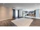 Open floor plan with hardwood floors connecting to kitchen with island seating and stainless appliances at 4064 Sunny Day Way, Kissimmee, FL 34744