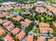 Wide aerial shot of the community featuring a pond, green space, and well-manicured landscaping at 4244 Messina Dr, Lake Mary, FL 32746