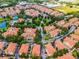 Panoramic aerial shot of a community featuring a pond, green spaces, and lush trees at 4244 Messina Dr, Lake Mary, FL 32746