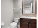 Bathroom featuring a toilet, vanity with sink, and a large mirror at 4244 Messina Dr, Lake Mary, FL 32746