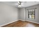 Bright bedroom featuring hardwood floors, a ceiling fan, and a large window at 4244 Messina Dr, Lake Mary, FL 32746