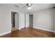 Bedroom features hardwood floors, a closet, and two doorways to the bathroom at 4244 Messina Dr, Lake Mary, FL 32746