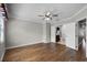 Spacious bedroom features hardwood floors, a ceiling fan, and an adjacent bathroom with double doors at 4244 Messina Dr, Lake Mary, FL 32746