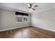 Bright bedroom featuring hardwood floors, a ceiling fan, and a window with natural light at 4244 Messina Dr, Lake Mary, FL 32746