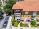 Aerial view of a multi-story townhome, showcasing the tile roof and verdant landscaping at 4244 Messina Dr, Lake Mary, FL 32746
