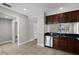 Open kitchen with dark wood cabinets, stainless steel appliances, and tile flooring at 4244 Messina Dr, Lake Mary, FL 32746