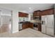 Well-appointed kitchen boasts stainless appliances, dark cabinets, and tile floor at 4244 Messina Dr, Lake Mary, FL 32746