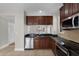 This cozy kitchen features brown cabinets, stainless steel appliances, and ample countertop space at 4244 Messina Dr, Lake Mary, FL 32746