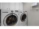 Well-equipped laundry room with front-load washer and dryer and white cabinets at 4244 Messina Dr, Lake Mary, FL 32746