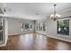 Bright living room featuring hardwood floors, large windows, and elegant lighting at 4244 Messina Dr, Lake Mary, FL 32746