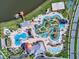 Aerial view of community featuring a lake, pool, lazy river, and recreation areas at 4973 Windermere Ave, Kissimmee, FL 34746