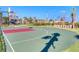 Outdoor community basketball court with green and red accents on a sunny day at 4973 Windermere Ave, Kissimmee, FL 34746