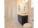 Bathroom featuring white marble floors, a toilet, and vanity with cabinet offering a clean and functional space at 4973 Windermere Ave, Kissimmee, FL 34746
