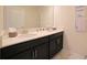 Bathroom with double sink, black cabinets, and marble floor. Modern mirror with inspirational signs on the wall at 4973 Windermere Ave, Kissimmee, FL 34746