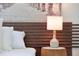Modern bedroom featuring a unique wood headboard and a stylish bedside lamp on a tree stump table at 4973 Windermere Ave, Kissimmee, FL 34746