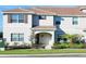 Inviting home exterior featuring a tile roof, manicured lawn, and lush landscaping at 4973 Windermere Ave, Kissimmee, FL 34746