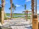 Relaxing hammock with waterfront view, swaying between palm trees, and set up with beach sand at 4973 Windermere Ave, Kissimmee, FL 34746