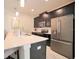 Modern kitchen with stainless steel appliances, granite countertops, and dark wood cabinetry at 4973 Windermere Ave, Kissimmee, FL 34746