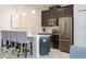 Contemporary kitchen with stainless steel appliances, barstool seating, and modern finishes at 4973 Windermere Ave, Kissimmee, FL 34746