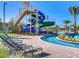 Community lazy river with sun loungers by the water, a waterslide, and landscaping at 4973 Windermere Ave, Kissimmee, FL 34746