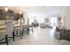 Spacious living room with modern decor, a stylish kitchen island, and elegant lighting at 4973 Windermere Ave, Kissimmee, FL 34746