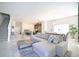Open-concept living room with a cozy couch, kitchen, and dining area at 4973 Windermere Ave, Kissimmee, FL 34746