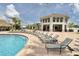 Poolside with many lounge chairs and a building nearby at 4973 Windermere Ave, Kissimmee, FL 34746