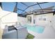 Relaxing outdoor pool area with a screened enclosure, dining set, and lounge chairs at 4973 Windermere Ave, Kissimmee, FL 34746