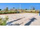 Community sand volleyball court on a sunny day with palm trees and blue skies in the background at 4973 Windermere Ave, Kissimmee, FL 34746