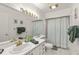 Bathroom features ample vanity space, cabinet storage, and coordinated green decor at 5237 Gateway Ave, Orlando, FL 32821