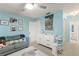 Bright Bedroom featuring baby changing station and a comfy couch, perfect for a new Gathering at 5237 Gateway Ave, Orlando, FL 32821
