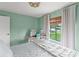 Light-filled bedroom offers a comfortable sleeping area and a separate desk for work or study at 5237 Gateway Ave, Orlando, FL 32821