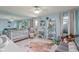 Cozy Bedroom with crib, decorative rug, seating, shelving and a ceiling fan for comfort at 5237 Gateway Ave, Orlando, FL 32821