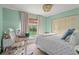 Bright bedroom featuring a window, neutral colored walls, and closet with bi-fold doors at 5237 Gateway Ave, Orlando, FL 32821
