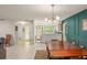 Open-concept dining room flows seamlessly into the kitchen, boasting modern lighting and tile flooring at 5237 Gateway Ave, Orlando, FL 32821