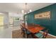 Chic dining area boasting green paneled walls, tile flooring, and modern light fixture next to the kitchen at 5237 Gateway Ave, Orlando, FL 32821