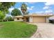 Charming single-story home featuring a two-car garage, mature landscaping, and a classic tiled roof at 5237 Gateway Ave, Orlando, FL 32821