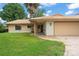 Charming single-story home featuring a tile roof, a well-kept lawn, and an attached two-car garage at 5237 Gateway Ave, Orlando, FL 32821