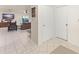 Bright hallway featuring tile flooring and neutral walls, providing access to various rooms at 5237 Gateway Ave, Orlando, FL 32821