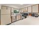 Well-lit kitchen with stainless steel appliances, white countertops, and ample cabinet space at 5237 Gateway Ave, Orlando, FL 32821