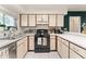 Bright eat-in kitchen with white cabinets, gas range, and tiled flooring at 5237 Gateway Ave, Orlando, FL 32821