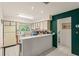 Eat-in kitchen features bright white cabinets, tiled floors, and a spacious serving bar at 5237 Gateway Ave, Orlando, FL 32821